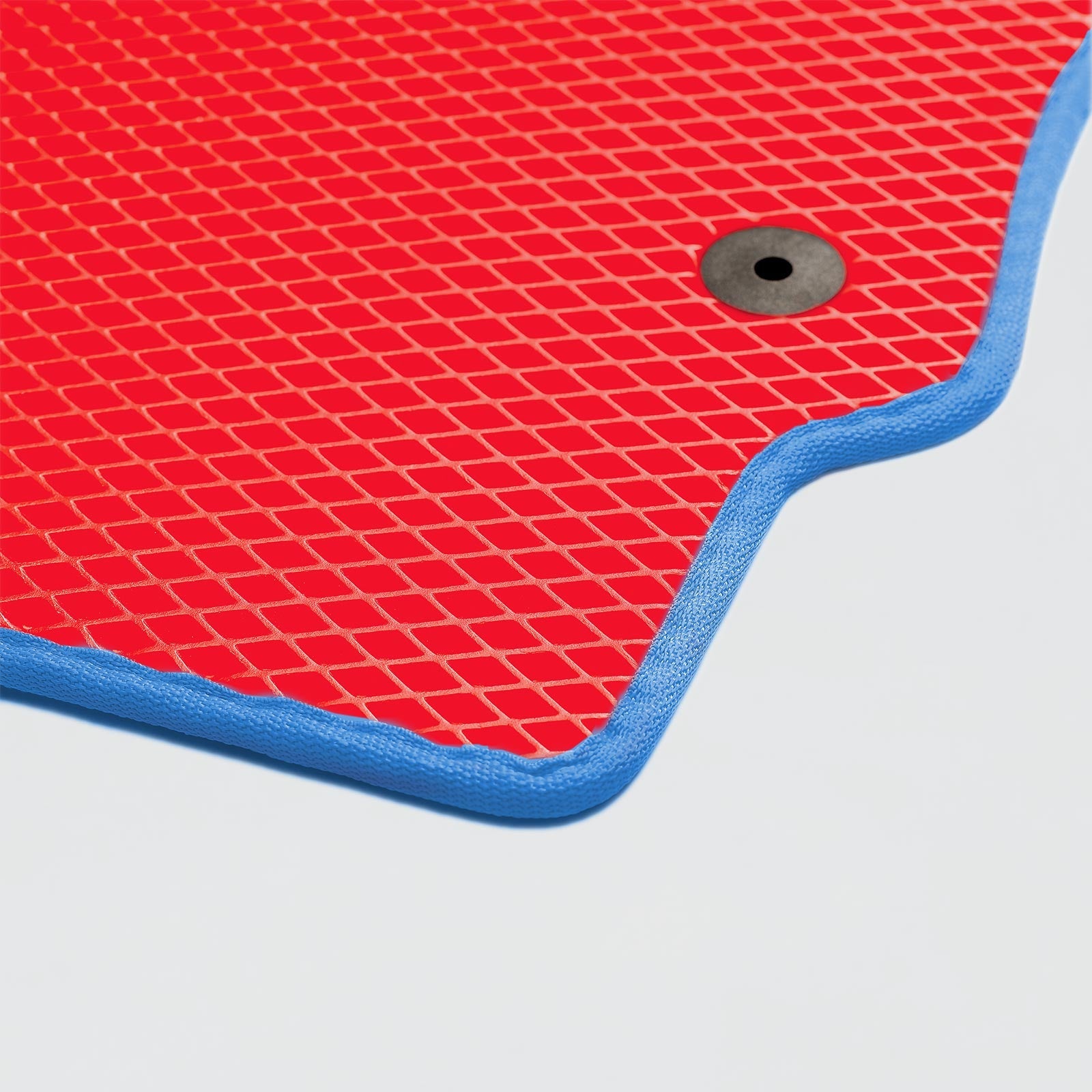 A red textured mat with a blue edge and a black hole for drainage.