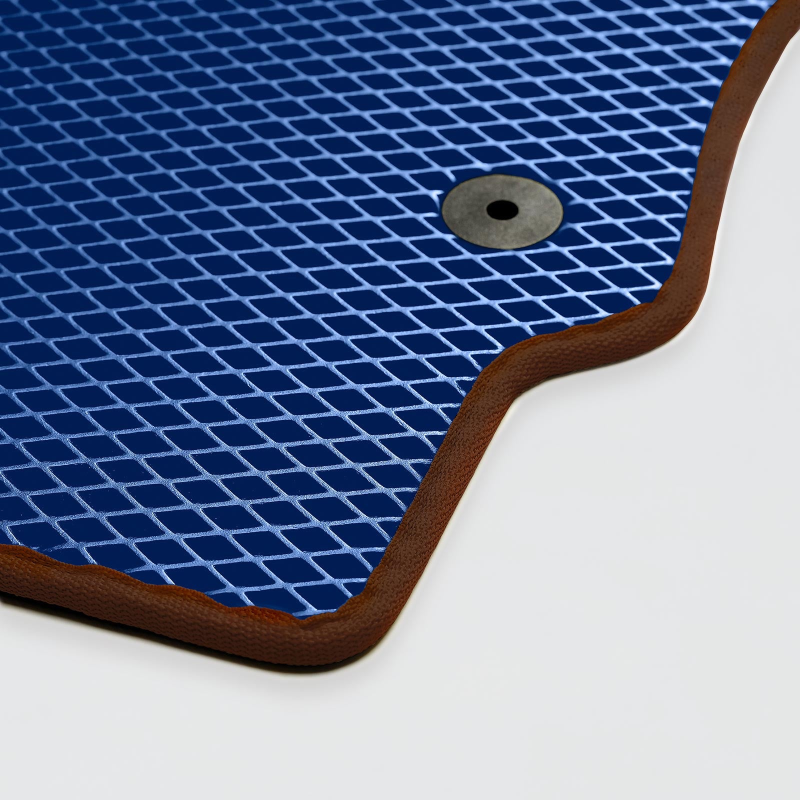 A blue rubber mat with a textured surface and a circular hole for drainage.